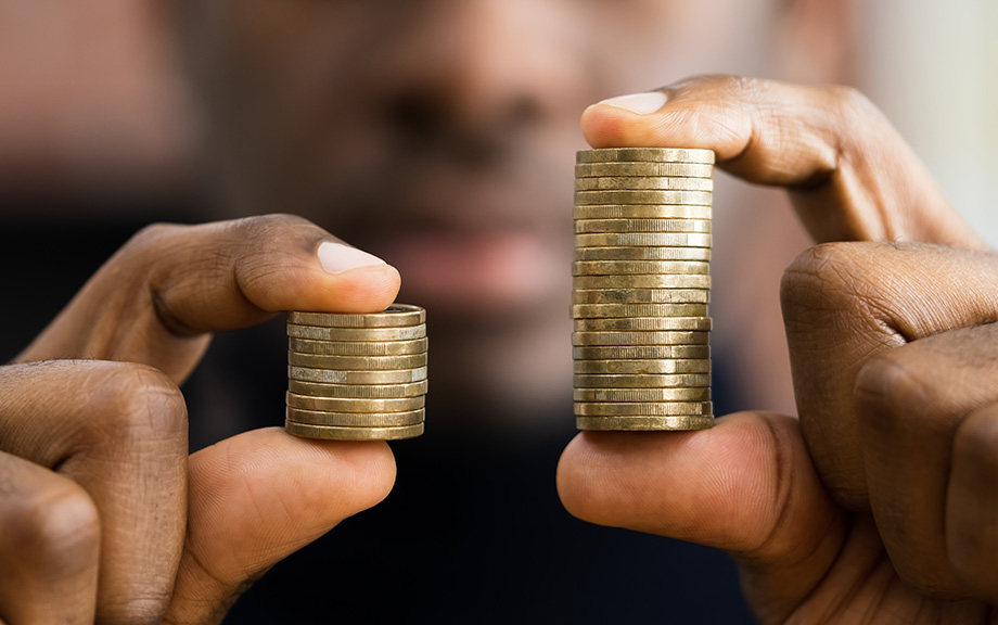 Decorative image: African American Man holding coins in his had showing money disparity.